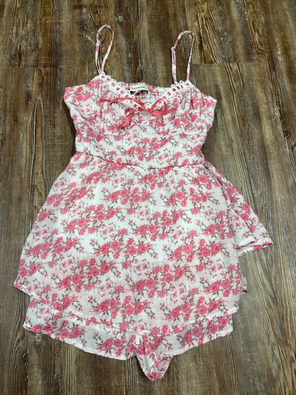 Pink floral summer romper with adjustable straps and bow detail